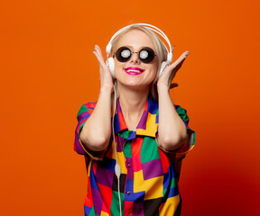 Style blonde in 90s clothes with headphones