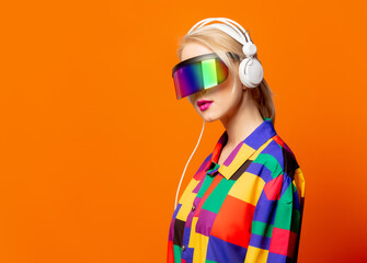 Style blonde in 90s clothes with VR glasses and headphones
