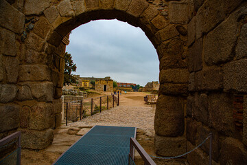 Ancient stone arch of entrance to monumental archaeological complex
