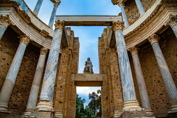 View of central curve of marble columns and stone statue