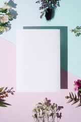 Blank paper over pastel background with flowers