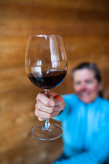 A happy woman enjoying a glass of red wine