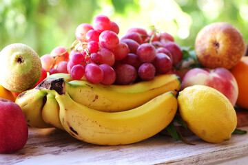 bunch of grapes, bananas and citric fruits