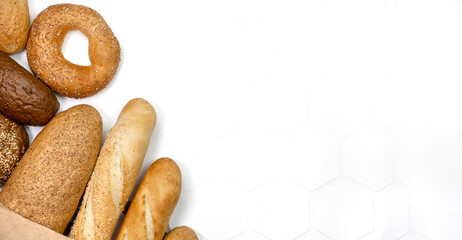 Different kinds of fresh bread on light background