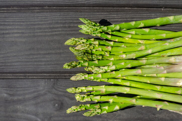 asparagus, natural farm food, wooden bowl and wooden background