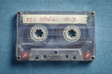 One vintage audio cassettes on blue sofa