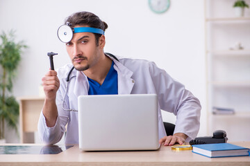 Young male doctor working in the clinic