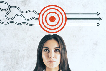 Businesswoman and drawing target with arrows