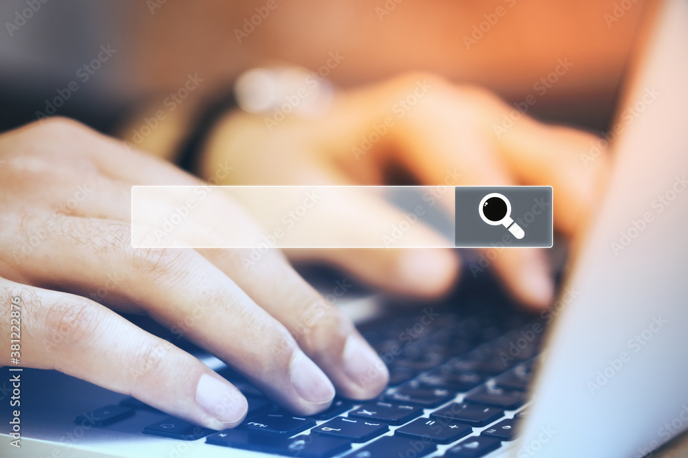Poster Hands typing on laptop keyboard with search bar.