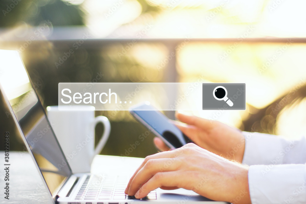 Poster hand using smartphone laptop with internet browser search bar.