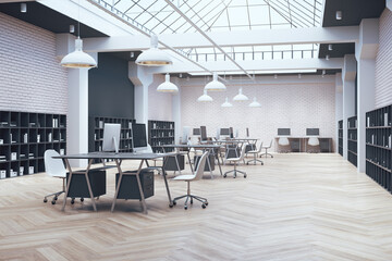 Coworking office in loft style with large skylight and shelf with documents.