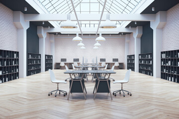 Coworking office in loft style with large skylight,  computers on table and shelf with documents.