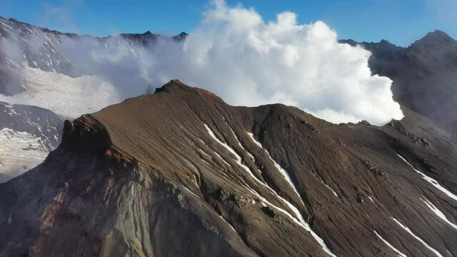 Aerial view of fumaroles in crater of active Mutnovsky volcano, Kamchatka, Russia, 4k
