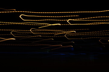 Golden threads, yellow neon signs on a black background. - obrazy, fototapety, plakaty