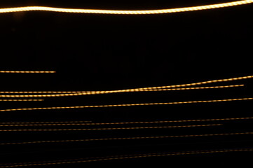 Golden threads, yellow neon signs on a black background.
