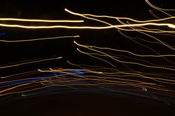 Golden threads, yellow neon signs on a black background.
