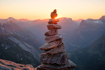 Stacked rocks with sunset overlooking mountains. Balanced rocks