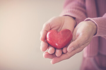 Woman holding red heart, health insurance, donation, happy charity volunteer concept, world mental...