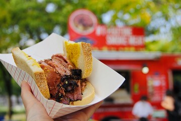 Trying popular street food in Montreal: Smoked meat sandwich (closeup)