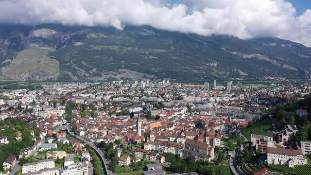View from drone of houses of swiss Chur city in mountain valley in sunny summer day