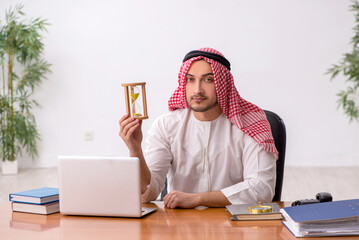 Young male arab employee working in the office
