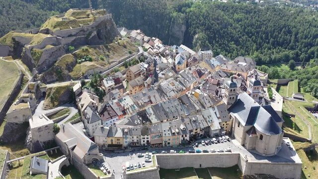 Picturesque autumn landscape with imposing medieval citadel on hilltop on background with French fortified township of Briancon. High quality 4k footage