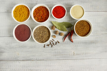 Spice on a wooden table - saffron, nutmeg, sumac and star anise. Fragrant seasonings. 