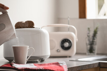 Breakfast time with electric kettle, toaster and an old vintage radio.