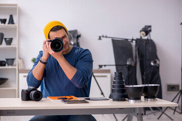 Young male photographer working in the studio