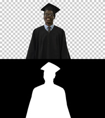 Happy African American Male Student in graduation robe walking,
