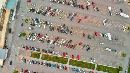 Aerial view of cars at large outdoor parking lots, USA. Outlet mall parking congestion and crowded...
