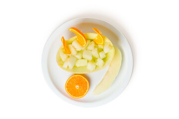 Top view of melon an orange cut on a plate isolated on a white background.