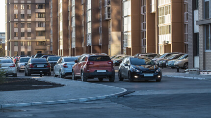 Cars parked in the courtyard of a residential building.