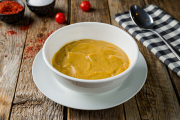 Soup cream of pumpkin on old wooden table