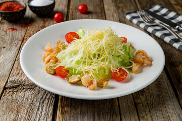 salad caesar with shrimps on white plate
