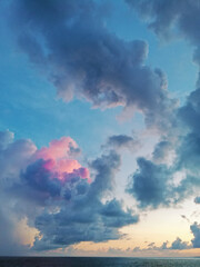 Beautiful cloudy sunset in the Caribbean Sea, the sunset produces pastel blue, orange and pink colors.