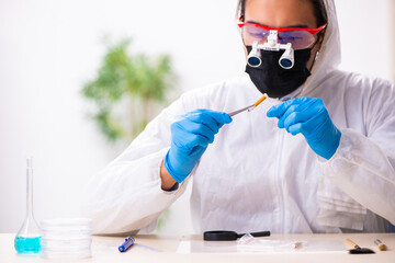 Male expert criminologist working in the lab for evidence