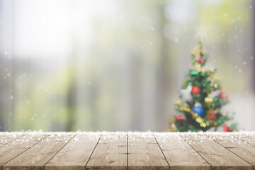 Empty wood table top on blur with bokeh Christmas tree and new's year decoration on window banner...