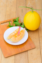 fresh golden melon with on wood plate