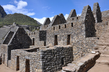 A close up view of the stone buildings and ruins inside the ancient Incan city of Machu Picchu