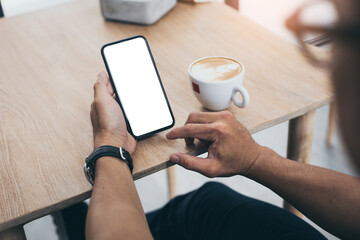 cell phone mockup blank white screen.man hand holding texting using mobile on desk at coffee shop.background empty space for advertise.work people contact marketing business,technology