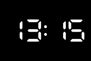 Real white led digital clock on black background