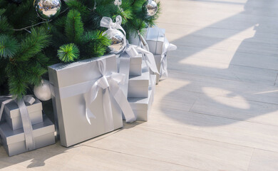 Presents and gifts under christmas tree in living room. Christmas time and Happy New Year celebration, Winter Holiday Concept
