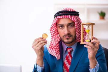 Young male arab employee working in office