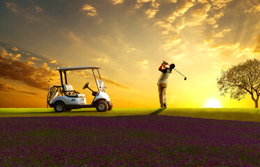 Woman professional golfer standing on golf course near golf cart with sun sky background - obrazy, fototapety, plakaty