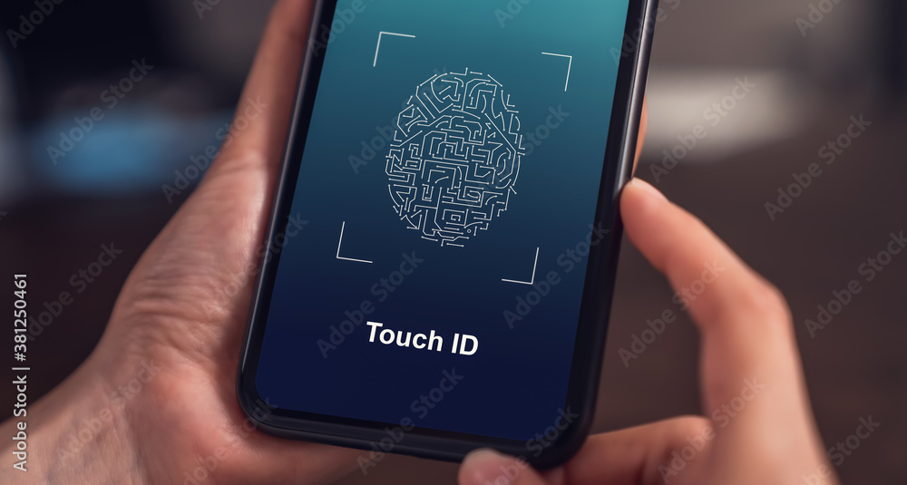 Poster close-up of hands scanning fingerprint on smartphone to unlock mobile phone on the table, concept se