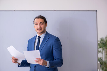 Young man employee in business presentation concept