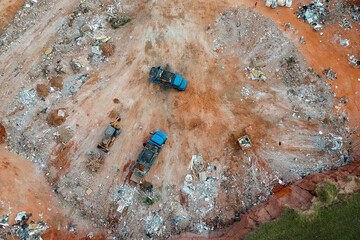 Aerial view made by drone of trucks unloading debris at the Landfill in Brazil