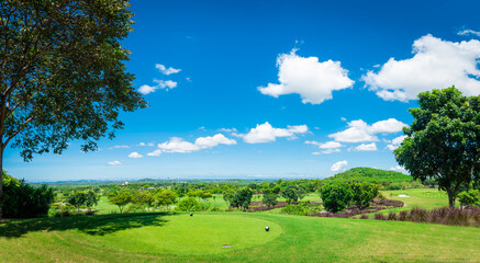 Beautiful view landscape in morning time green grass at golf course ,big trees, sand bunker and mist with sunlight rays background