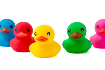 Five multi-colored rubber ducks on white background. Rubber ducks isolated over white